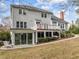 Expansive backyard with a deck, screened-in porch, mature landscaping, and an American flag at 105 Aberson Ct, Cary, NC 27519