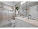 This bathroom has a double vanity, a large mirror, a shower with a glass door, and light blue patterned tile floor at 105 Aberson Ct, Cary, NC 27519