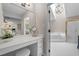 Bathroom featuring a vanity and a tub and shower combination with light tile and gold trim at 105 Aberson Ct, Cary, NC 27519