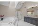 Bright bathroom features a soaking tub, glass shower, and a vanity with marble countertops at 105 Aberson Ct, Cary, NC 27519