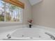 Close up of a soaking tub in a bright bathroom at 105 Aberson Ct, Cary, NC 27519