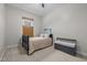 This bedroom has neutral walls, carpet, a small bed, natural window light, and a storage chest at 105 Aberson Ct, Cary, NC 27519