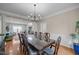 Dining room with modern light fixture, hardwood floors and an open concept layout at 105 Aberson Ct, Cary, NC 27519