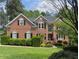 Stately brick home with manicured lawn and lush landscaping at 105 Aberson Ct, Cary, NC 27519