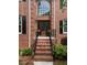Brick home featuring a grand entry with a decorative glass front door and brick steps with metal railings at 105 Aberson Ct, Cary, NC 27519