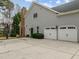 Home exterior with a two-car garage, basketball hoop, a well-maintained driveway, and neutral-colored siding at 105 Aberson Ct, Cary, NC 27519