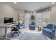 Bright home office featuring large windows, comfortable seating, and a functional workspace at 105 Aberson Ct, Cary, NC 27519