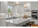 Bright kitchen with marble countertops, kitchen island and modern appliances at 105 Aberson Ct, Cary, NC 27519