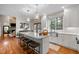 Bright kitchen with a center island, pendant lighting, stainless steel appliances, and hardwood floors at 105 Aberson Ct, Cary, NC 27519