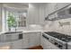 Modern kitchen features stainless steel appliances, white cabinets, and sleek countertops at 105 Aberson Ct, Cary, NC 27519