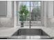 Kitchen sink with stainless steel basin and modern faucet, offering a garden window view at 105 Aberson Ct, Cary, NC 27519