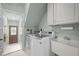 Well-equipped laundry room featuring modern appliances and ample cabinet space, plus utility sink at 105 Aberson Ct, Cary, NC 27519