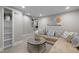 Basement living room featuring a sectional sofa, round wood coffee table, and neutral decor at 105 Aberson Ct, Cary, NC 27519