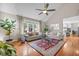 Bright living room with hardwood floors, large windows, and comfortable seating at 105 Aberson Ct, Cary, NC 27519