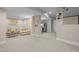 Open concept living room with carpet and recessed lighting; fridge in small kitchenette visible at 105 Aberson Ct, Cary, NC 27519