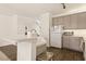 A well-lit kitchen featuring gray cabinets and modern appliances offers a functional cooking space at 108 Colwick Ln, Morrisville, NC 27560