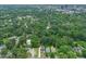 Expansive aerial view highlighting the dense trees and skyline surrounding the houses with an overarching cityscape at 109 W Markham Ave, Durham, NC 27701