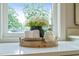 Bathroom counter with decorative vase, rolled towels, and soap dispenser with a large sunny window view at 109 W Markham Ave, Durham, NC 27701