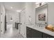Bathroom featuring a gray vanity, striking hexagon tile flooring, and bright white walls at 109 W Markham Ave, Durham, NC 27701