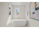 Bright bathtub with natural light and abstract art at 109 W Markham Ave, Durham, NC 27701