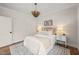 Bedroom with a hanging light fixture, hardwood floors, a window, and modern decor at 109 W Markham Ave, Durham, NC 27701