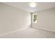 Cozy bedroom with neutral carpet, white trim, and a sunlit window at 109 W Markham Ave, Durham, NC 27701