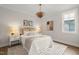 Beautifully staged bedroom with a stylish chandelier, decor, and a large window at 109 W Markham Ave, Durham, NC 27701