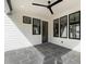 Comfortable porch with tiled floor, ceiling fan, and multiple windows at 109 W Markham Ave, Durham, NC 27701