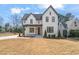Striking two-story home with modern farmhouse design and lush front lawn and attractive landscaping at 109 W Markham Ave, Durham, NC 27701