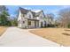 Stunning two-story home with a modern facade, long driveway, and well-manicured lawn at 109 W Markham Ave, Durham, NC 27701