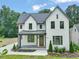 Charming two-story home with a manicured lawn and stylish architectural details at 109 W Markham Ave, Durham, NC 27701
