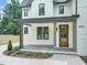 Inviting front porch with stone flooring and a beautiful wood door at 109 W Markham Ave, Durham, NC 27701