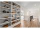 Bright hallway featuring custom built-in shelving and hardwood floors at 109 W Markham Ave, Durham, NC 27701