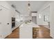Spacious white kitchen with island, bar stools, marble backsplash, and stainless steel appliances at 109 W Markham Ave, Durham, NC 27701