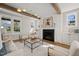 Elegant living room with wood beams, fireplace and modern light fixture at 109 W Markham Ave, Durham, NC 27701