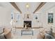 Sophisticated living room featuring wood beams, fireplace with mantle, and stylish decor at 109 W Markham Ave, Durham, NC 27701