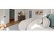 Stylishly decorated main bedroom with wood floors, dresser with round mirror, and neutral colors at 109 W Markham Ave, Durham, NC 27701