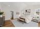 Bright main bedroom featuring hardwood floors, vaulted ceilings, and neutral decor at 109 W Markham Ave, Durham, NC 27701