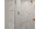 Luxurious walk-in shower with marble-look tile and sleek gold fixtures at 109 W Markham Ave, Durham, NC 27701