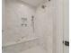 Shower with seat and white textured tile at 109 W Markham Ave, Durham, NC 27701