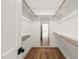 Walk-in closet with hardwood floors and mirror at 109 W Markham Ave, Durham, NC 27701