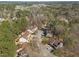 Aerial view of a residential neighborhood surrounded by lush forests with mature trees and well-maintained lawns at 12 Citation Dr, Durham, NC 27713