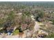 Panoramic aerial view of a neighborhood surrounded by lush forests with mature trees and well-maintained lawns at 12 Citation Dr, Durham, NC 27713