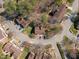 Aerial view of homes in a quiet neighborhood with mature trees, well-maintained lawns, and landscaped yards at 12 Citation Dr, Durham, NC 27713