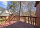 Wooden back deck overlooking leafy green backyard and other properties behind it at 12 Citation Dr, Durham, NC 27713