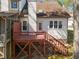 Back of house and backyard featuring a wooden deck with a stairway, lawn, and trees at 12 Citation Dr, Durham, NC 27713