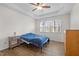 Cozy bedroom with ceiling fan, hardwood floors, and three-panel windows at 12 Citation Dr, Durham, NC 27713