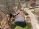 Aerial view of home with brown shingled roof, light siding, a rear deck and stairs, and a manicured lawn at 12 Citation Dr, Durham, NC 27713