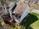 Aerial view of home with brown shingled roof, light siding, a rear deck and stairs, and a manicured lawn at 12 Citation Dr, Durham, NC 27713