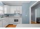 Bright kitchen featuring white appliances and cabinetry, open to the living area at 12 Citation Dr, Durham, NC 27713